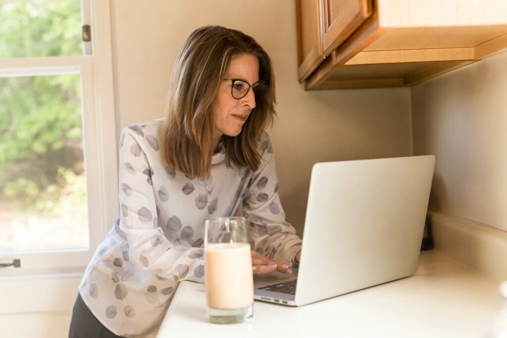 A homeowner reading through paperwork with a pen in hand.